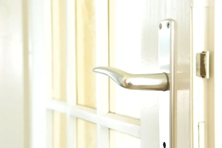 Lock repair or replacement in Sheffield – white door with a lever handle and locking plate, Locksmith Sheffield guide to which your door needs
